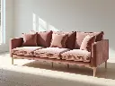 A modern 3-seater sofa in a minimalist living room. The sofa has clean lines, plush cushions, and a soft velvet texture. It sits on wooden legs and is placed against a plain white wall with light wooden (2).webp